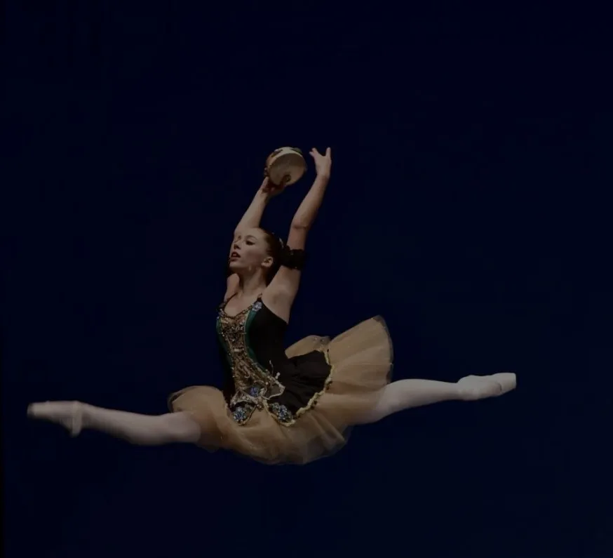 Koltun Ballet Boston dancer mid-leap on stage